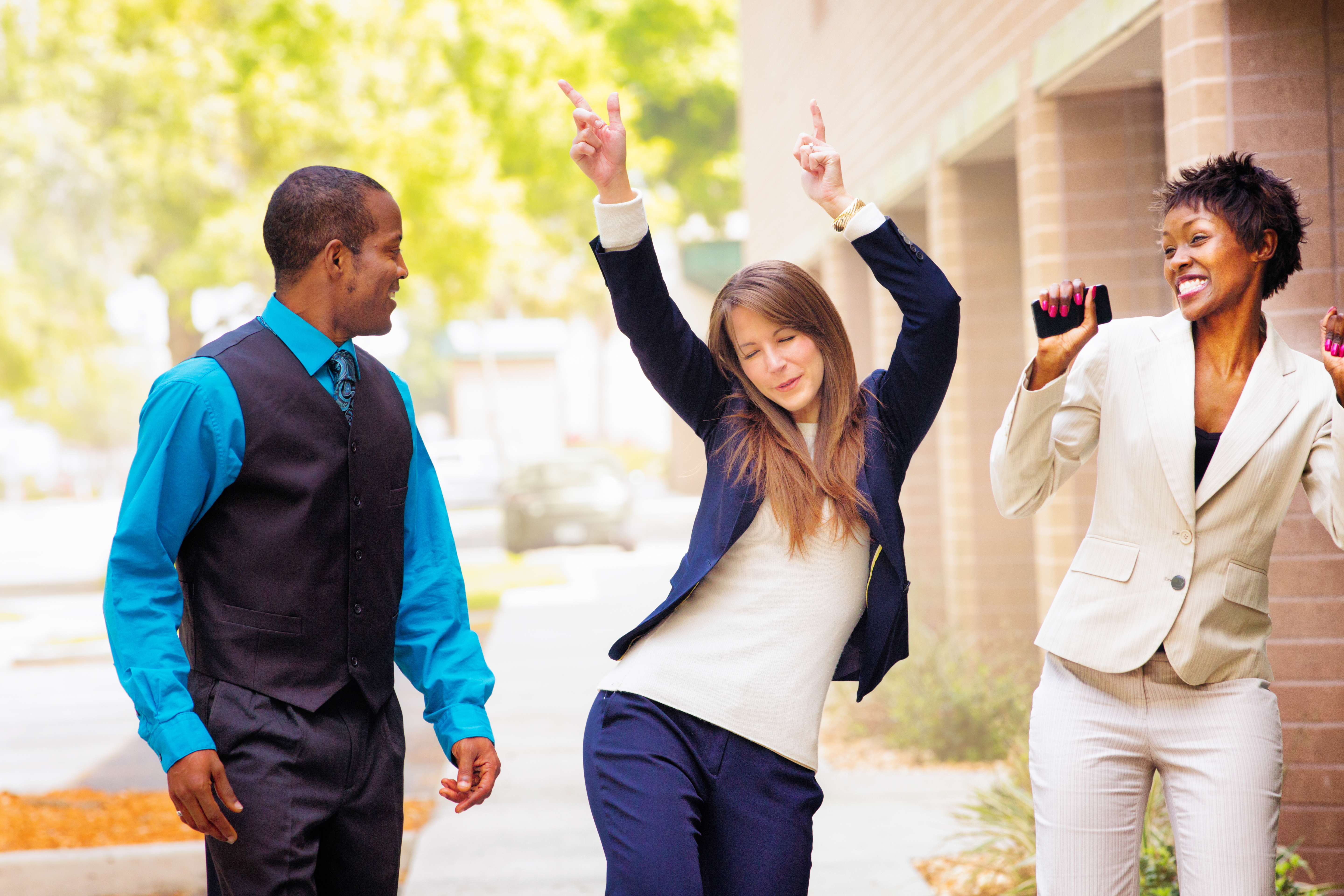 Office worker team does victory dance after receiving good news