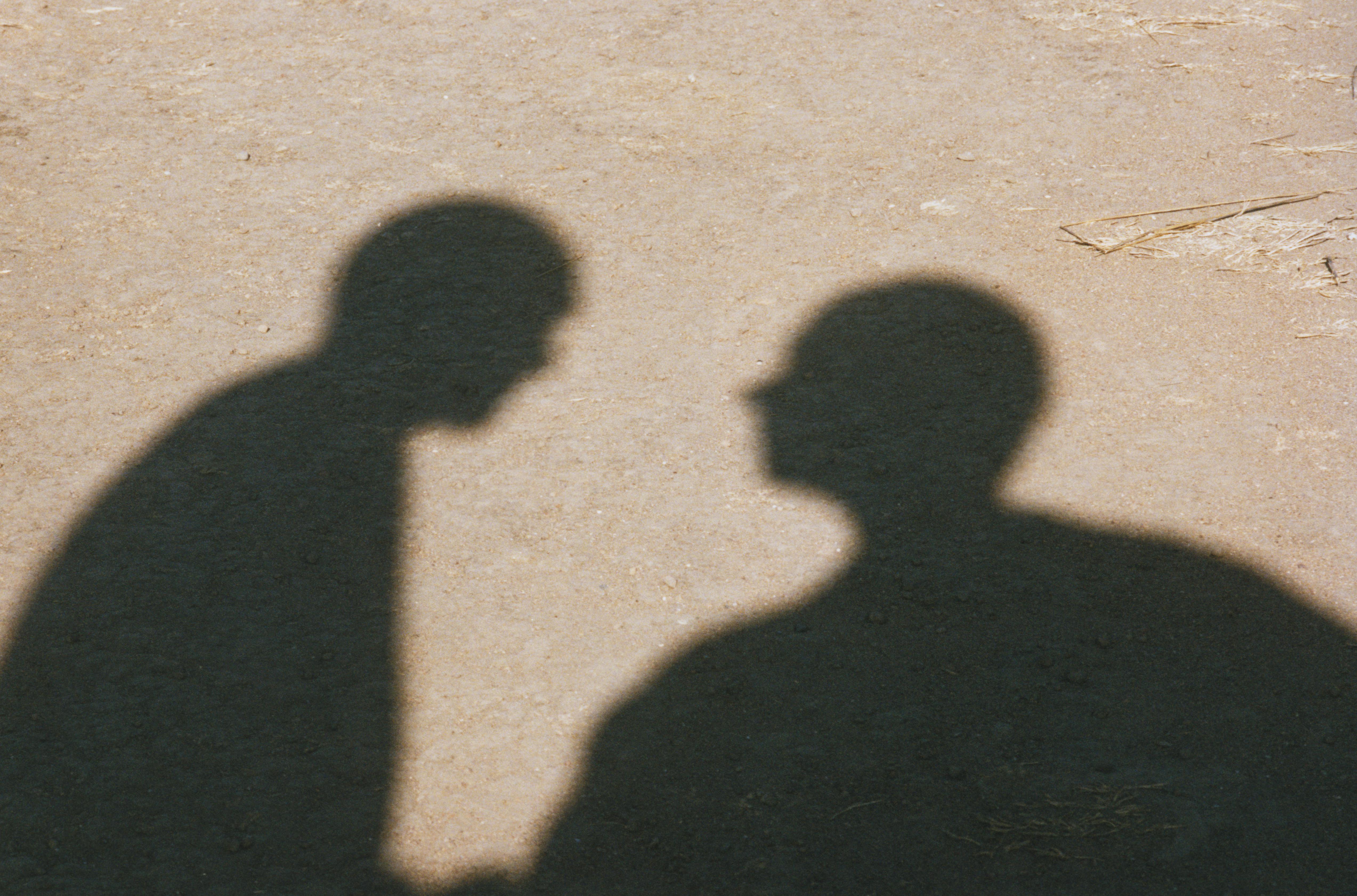 Shadows of Two Men in Desert
