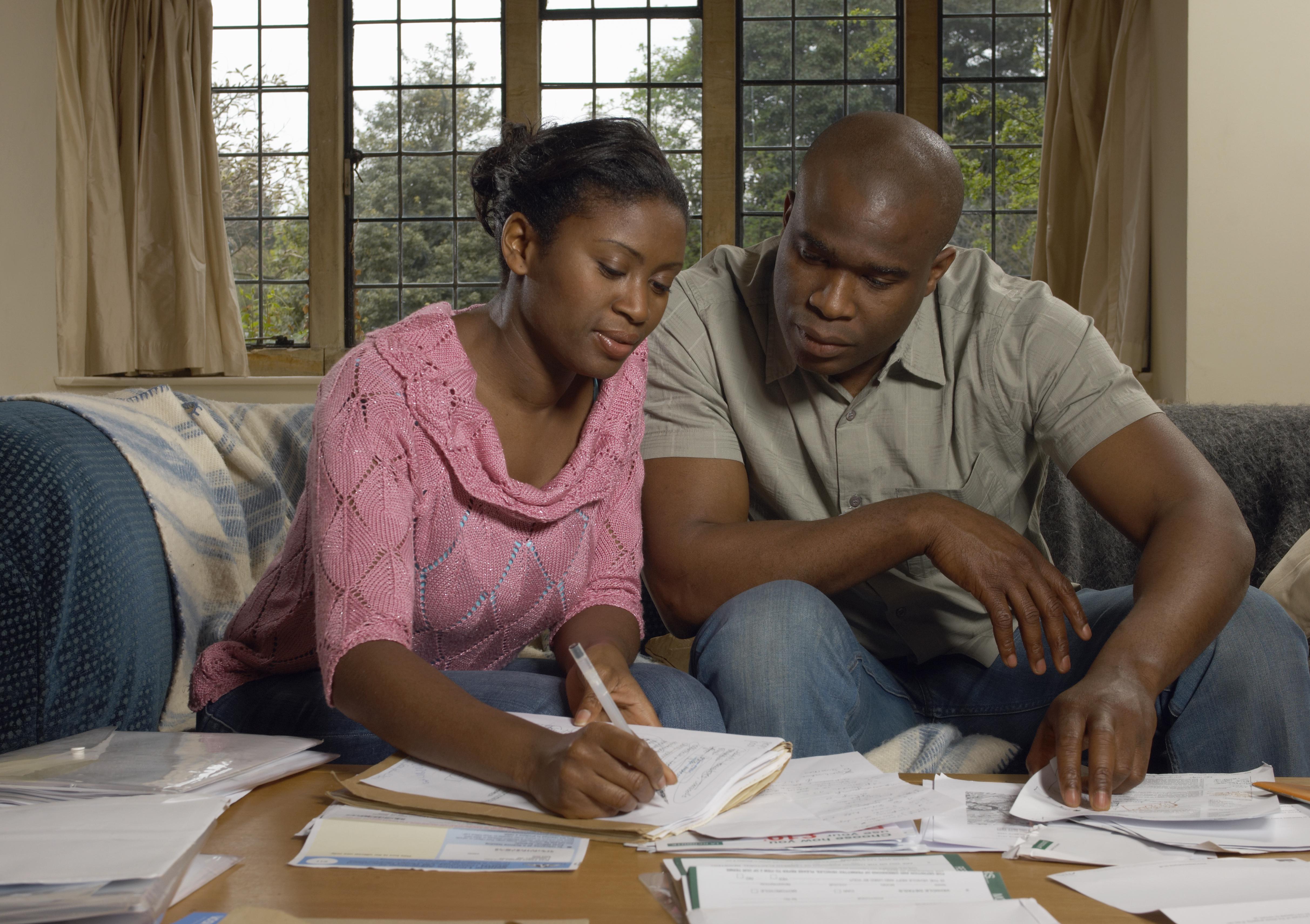 Couple on sofa doing home accounts