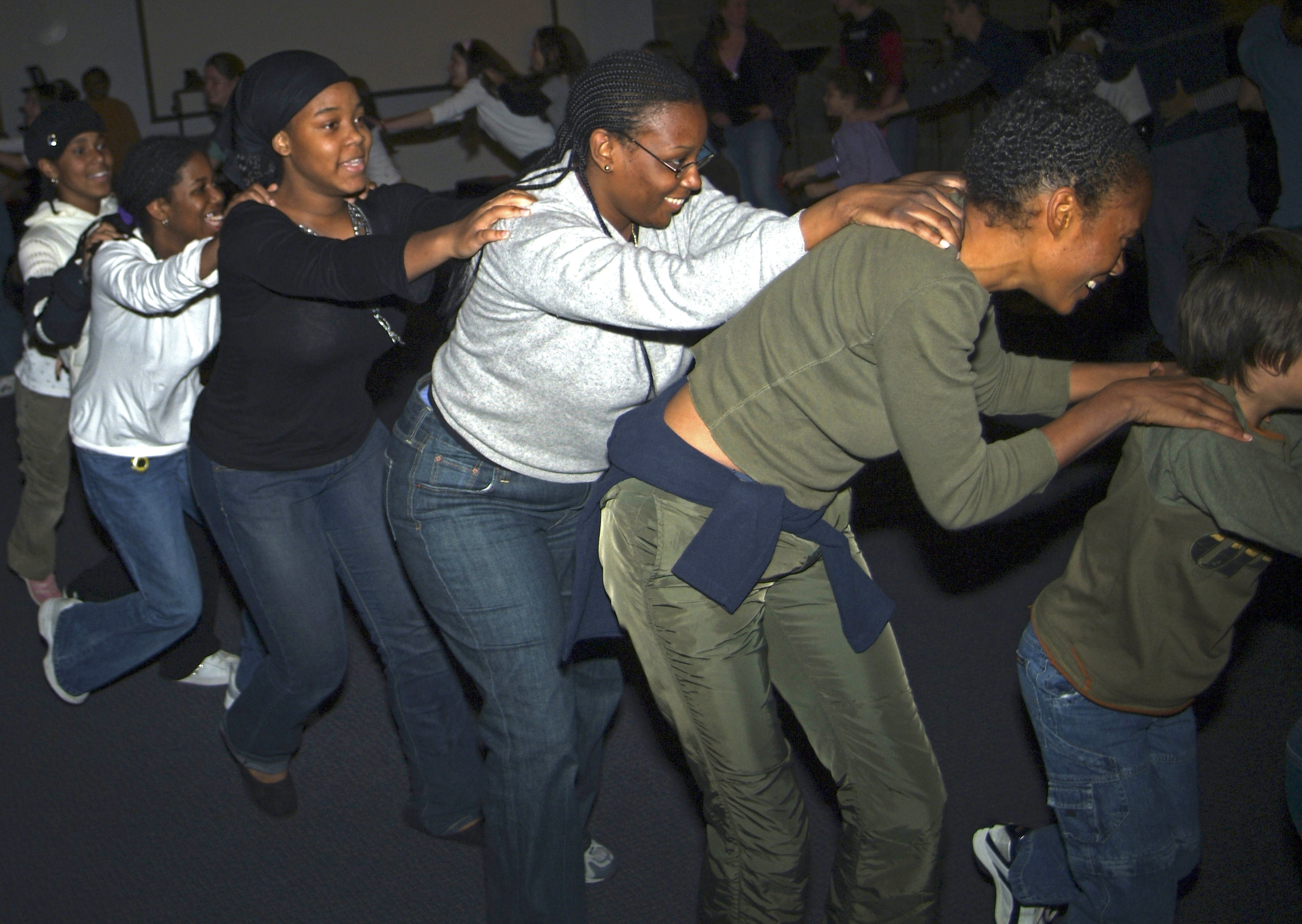 People dancing in a conga line