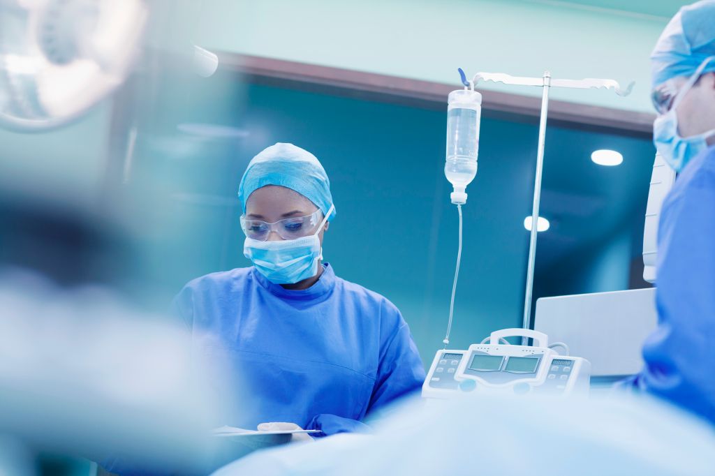 Doctors performing surgery in hospital operating room