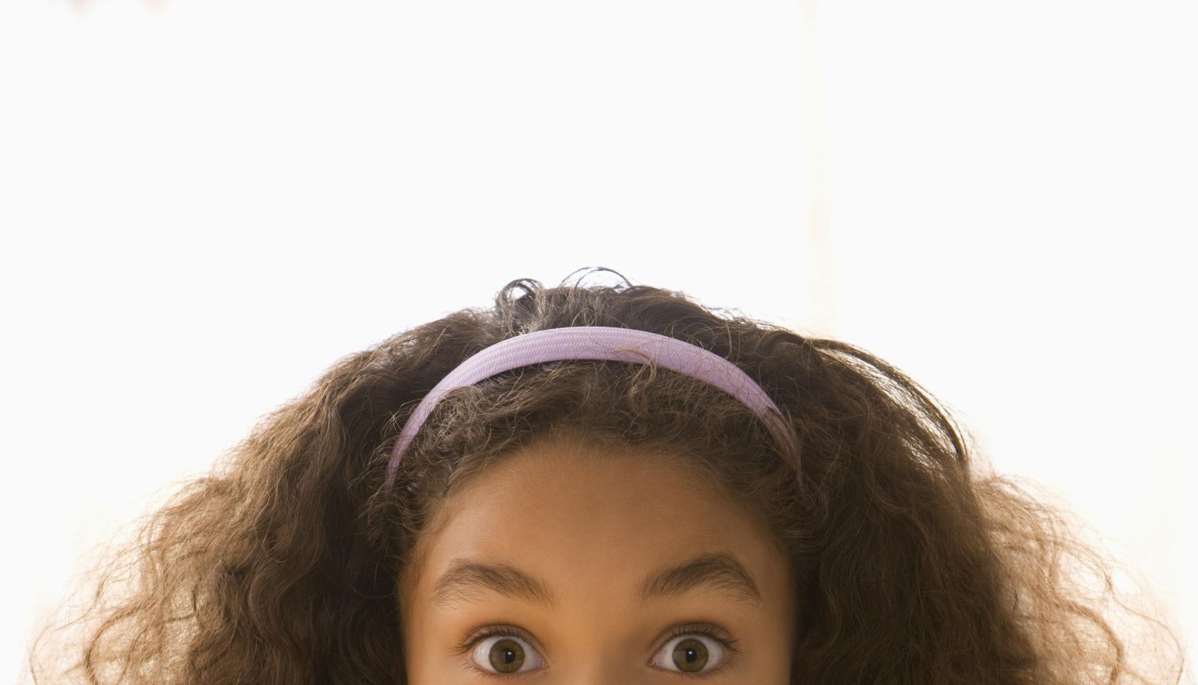 Mixed race girl making shhh gesture