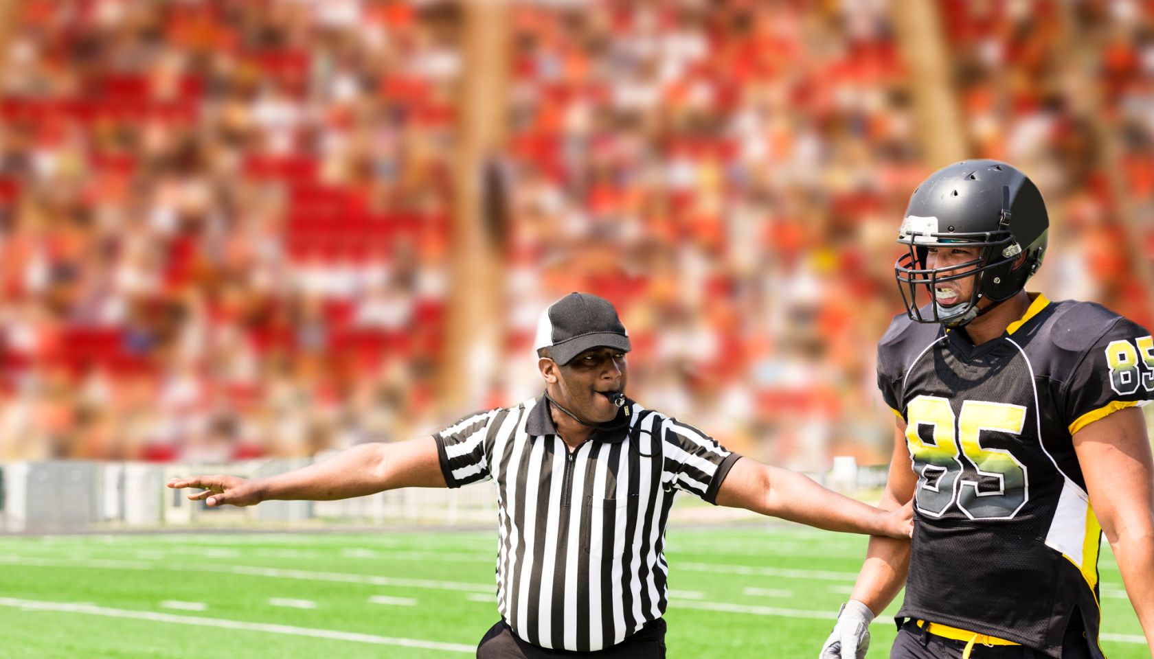 American football referee signals a play during the game. Player.